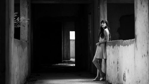 Woman standing in abandoned building