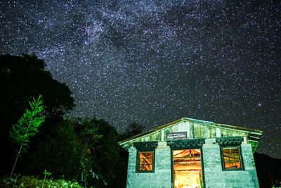 Illuminated building against sky at night