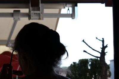 Portrait of woman looking through car window