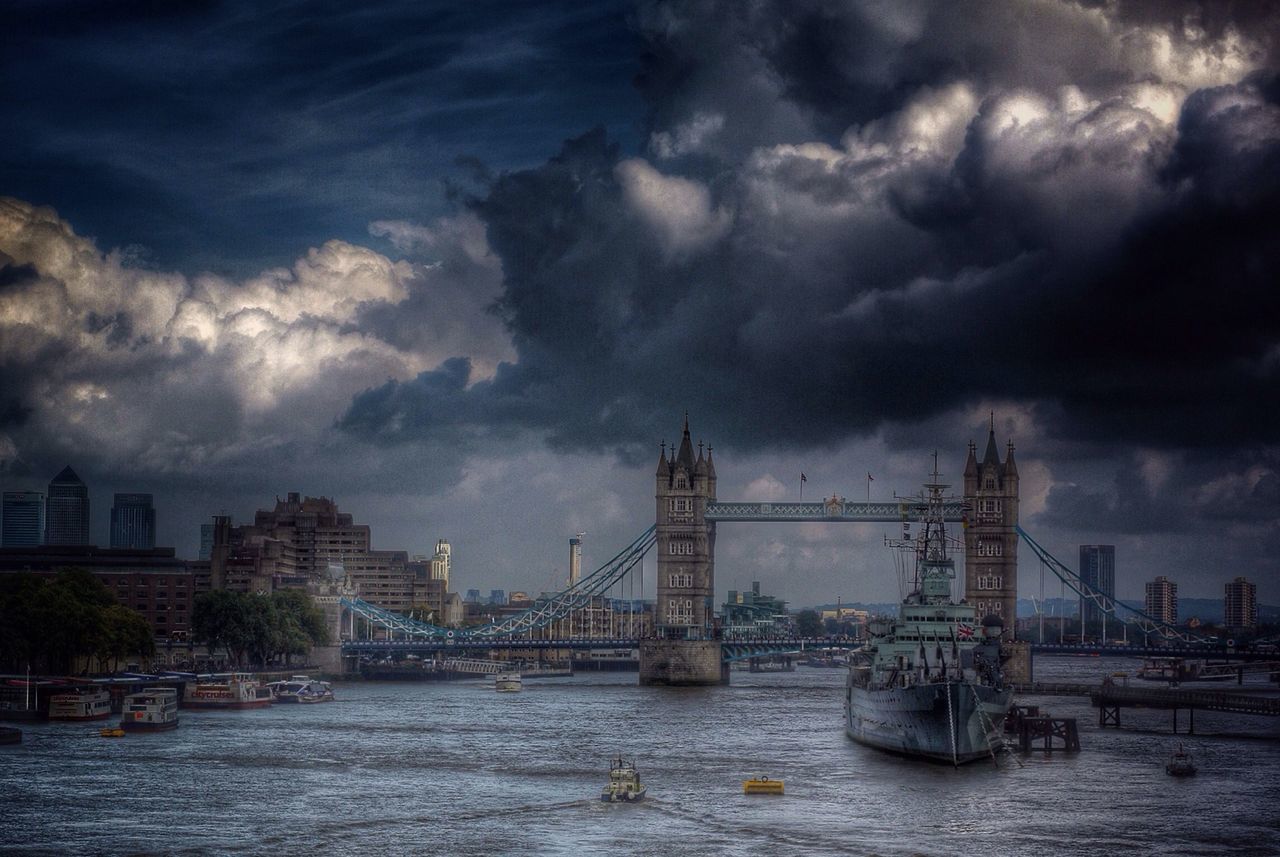 water, sky, architecture, built structure, waterfront, cloud - sky, building exterior, cloudy, nautical vessel, river, harbor, transportation, city, sea, cloud, crane - construction machinery, commercial dock, mode of transport, weather, overcast