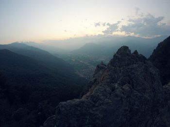 Scenic view of mountains against sky at sunset