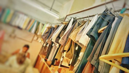 Close-up of clothes hanging in store