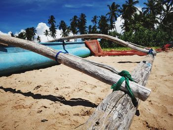 Fishing boat on beach against sky