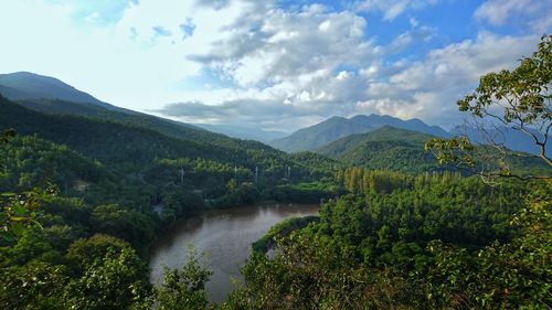 Scenic view of river amidst mountains against sky