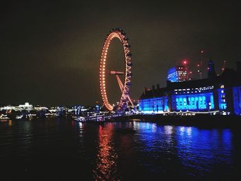 Illuminated ferris wheel at night