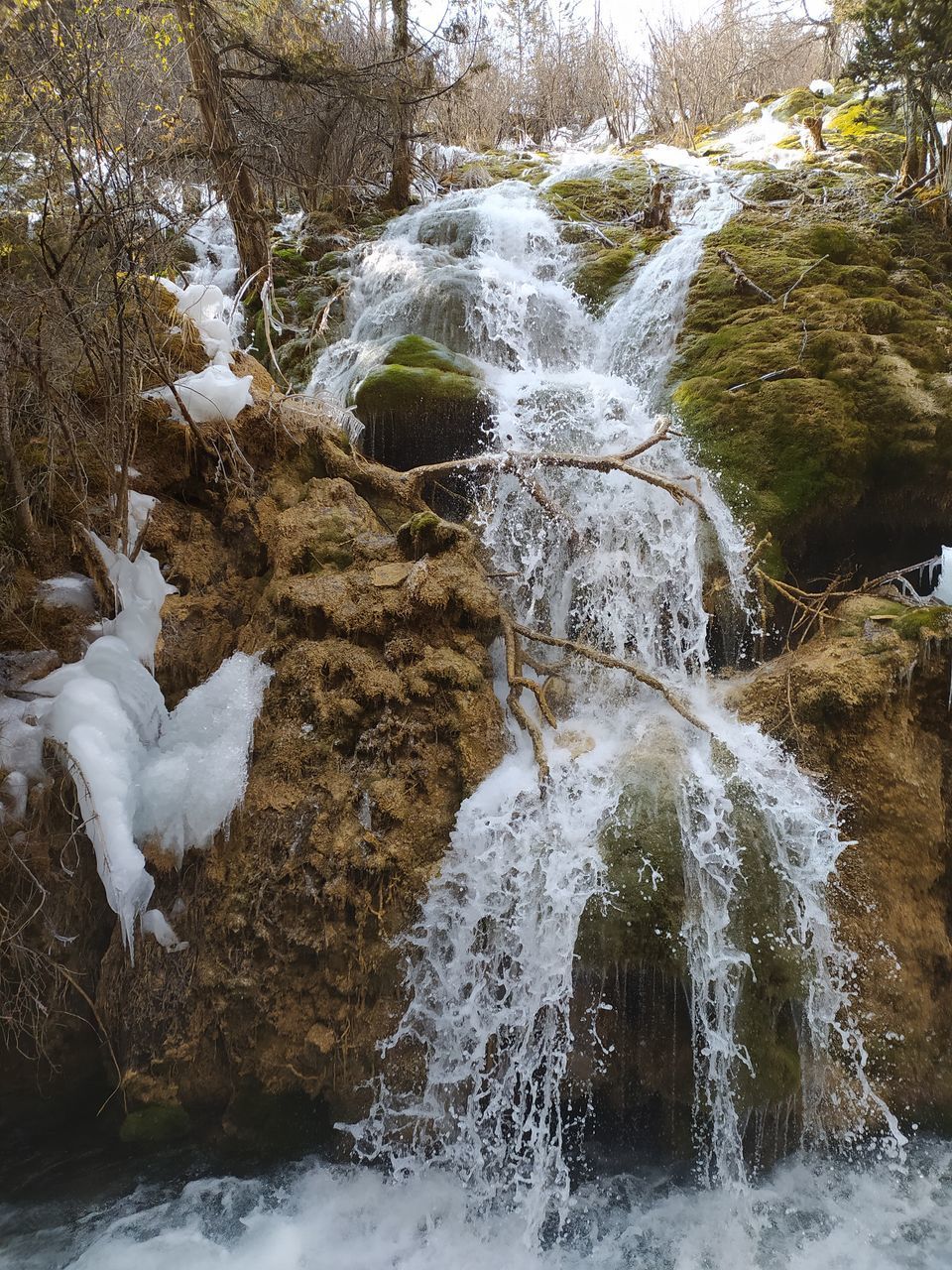 WATER FLOWING THROUGH ROCKS ON LAND