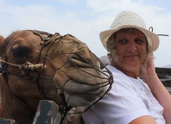 Mature woman looking at camel