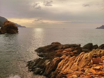 Scenic view of sea against sky at sunset