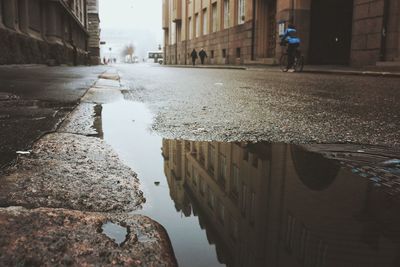 Reflection of buildings in puddle