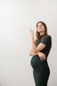 Young woman standing against white background