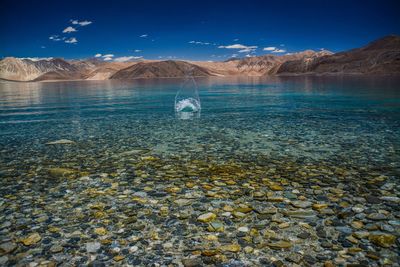 Scenic view of lake against blue sky