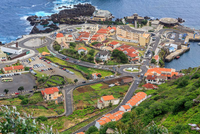 High angle view of townscape by sea