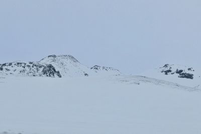 Low angle view of snow covered mountain against clear sky