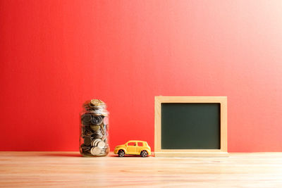 Objects on table against red wall