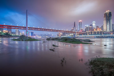 View of suspension bridge with city in background