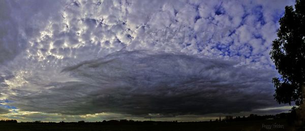 Scenic view of landscape against cloudy sky