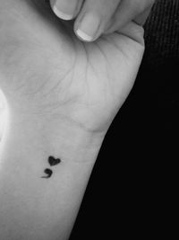 Close-up of person hand over black background