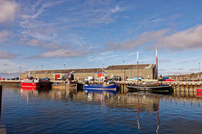 Boats moored at harbor