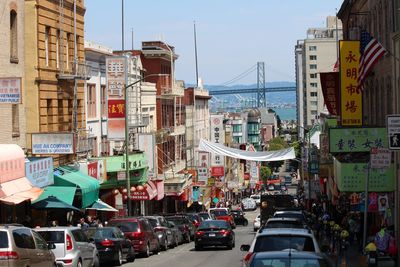 Cars on street amidst buildings in city