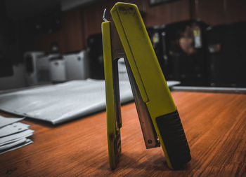 Close-up of stationary tool stapler on table at office