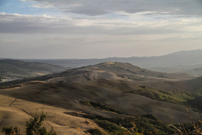 Scenic view of mountains against cloudy sky