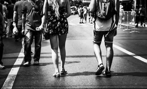 Low section of people walking on street