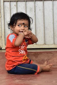 Portrait of cute boy sitting outdoors