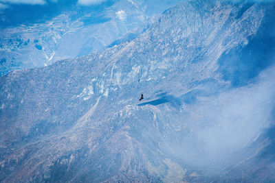 Scenic view of mountains against blue sky