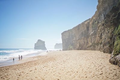 Scenic view of beach against clear blue sky