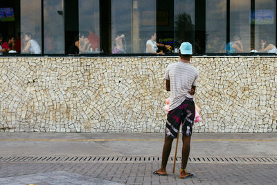 Rear view of man working in city