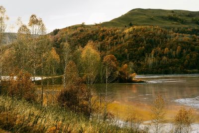 Scenic view of cyanide lake against sky in autumn