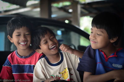 Portrait of a smiling girl with people in background