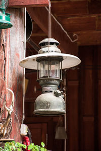 Close-up of lantern hanging against wall