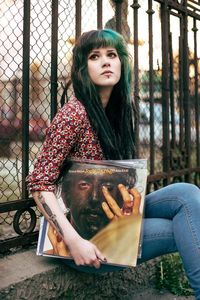 Portrait of young woman sitting outdoors