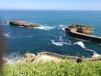 High angle view of rocks in sea against sky