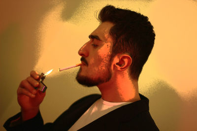 Close-up of young man smoking cigarette