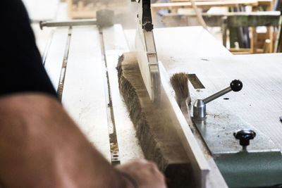 Close up of carpenter sawing oak wood