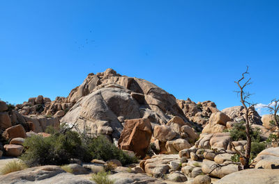 Rock formation against clear blue sky