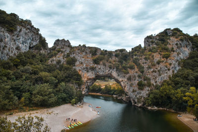 Scenic view of river amidst mountains against sky