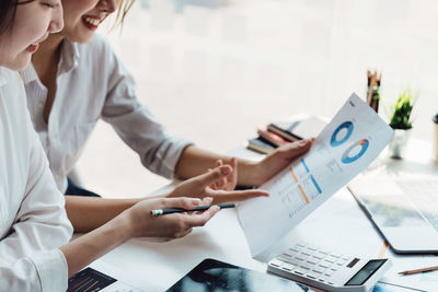 Midsection of business colleagues working in office