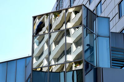 Low angle view of modern building against clear blue sky