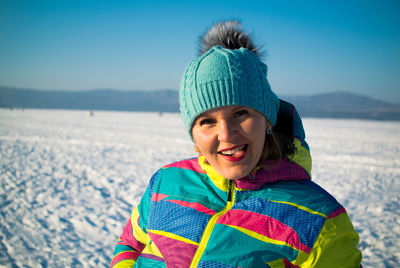 Portrait of smiling young woman in snow