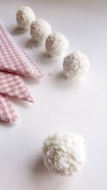 Grated coconut balls by napkins on table