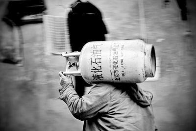 Rear view of woman standing in factory