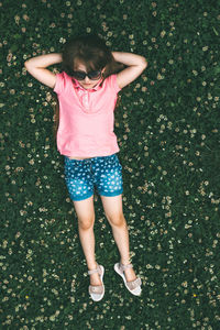 High angle view of girl lying on field