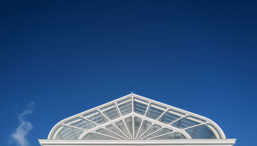 Low angle view of building against clear blue sky