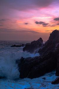 Scenic view of sea against orange sky