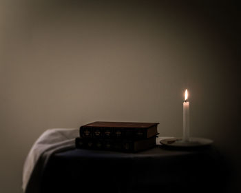 Close-up of illuminated candles on table