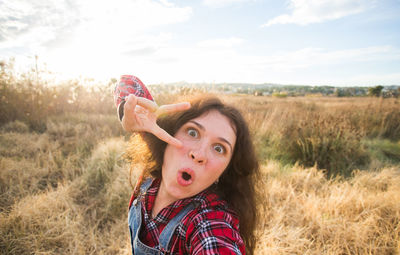 Portrait of teenage girl on field