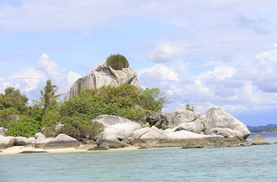 Rocks in sea against sky